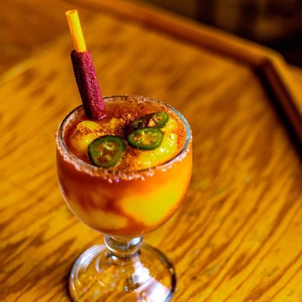 Mi Casa Mexican Restaurant's mango margarita with jalapeño slices and a chili-dusted straw.